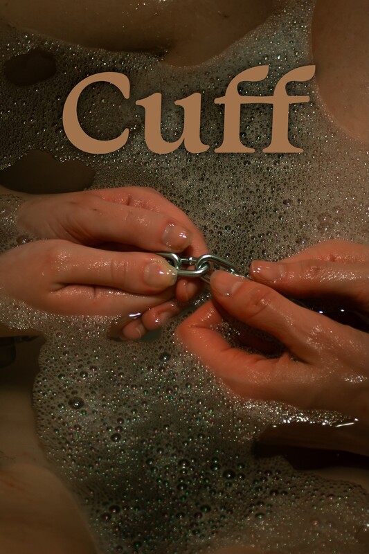 Hands are shown manipulating a short metal chain in a bubbly bath, with the word Cuff prominently displayed above.